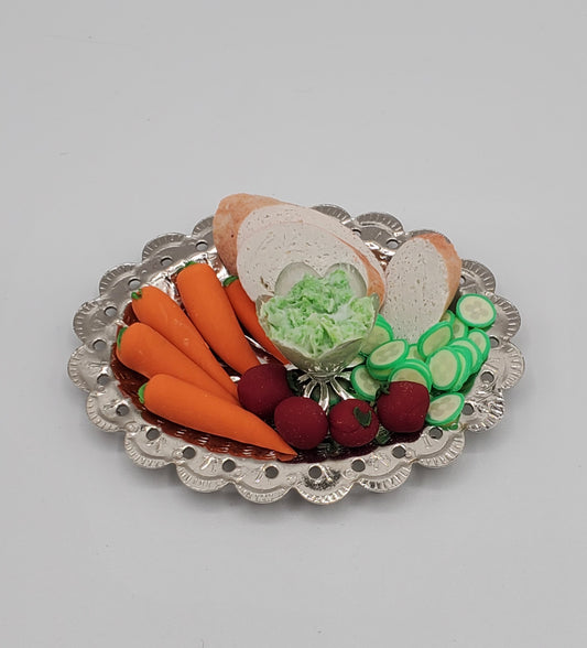 Chef Ginas miniature veggie platter with carrots cucumbers beets and lettuce on decorative silver tray