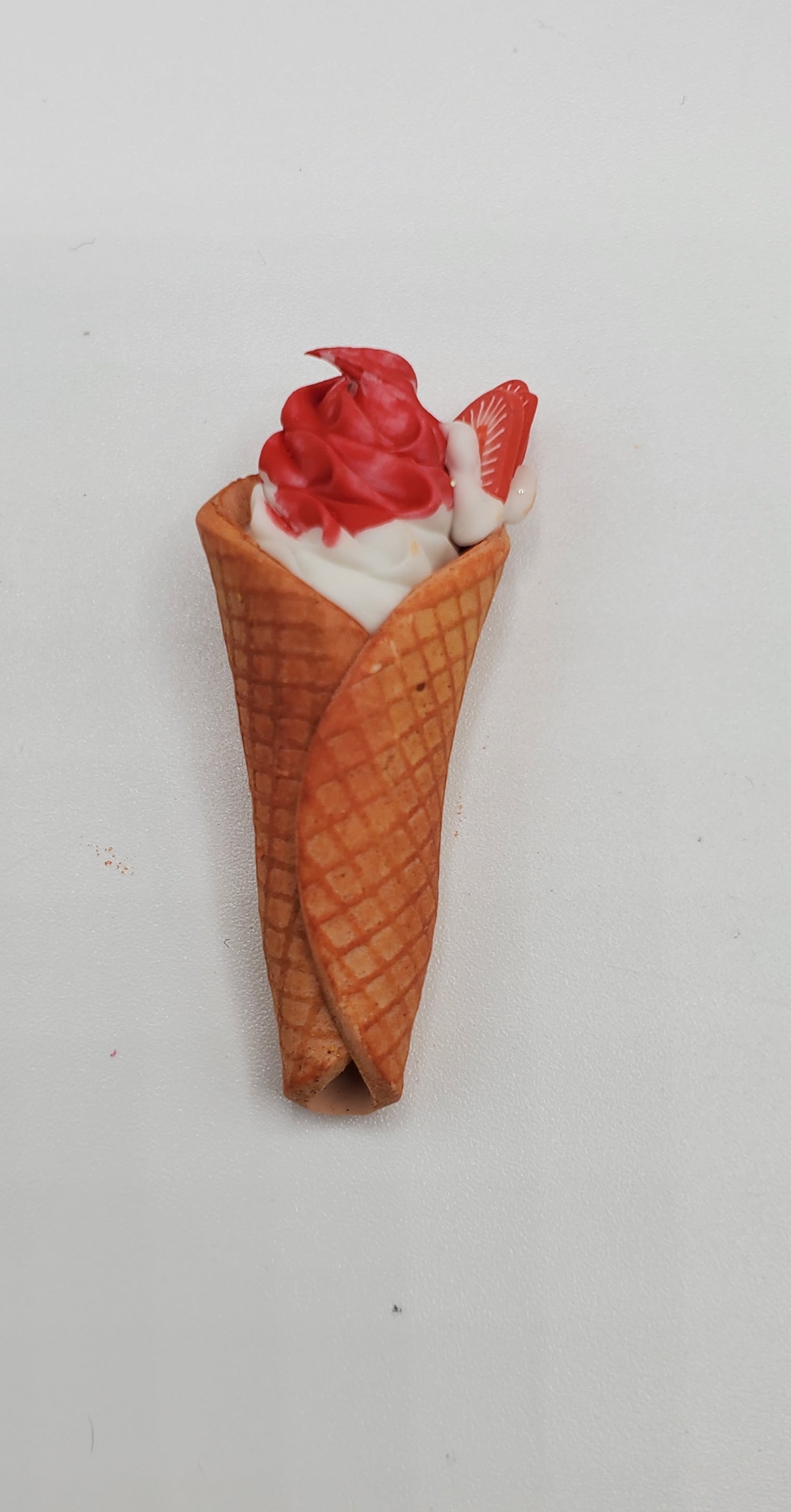 Chef Gina's miniature waffle cone ice creams with red and white swirled topping in a crispy cone