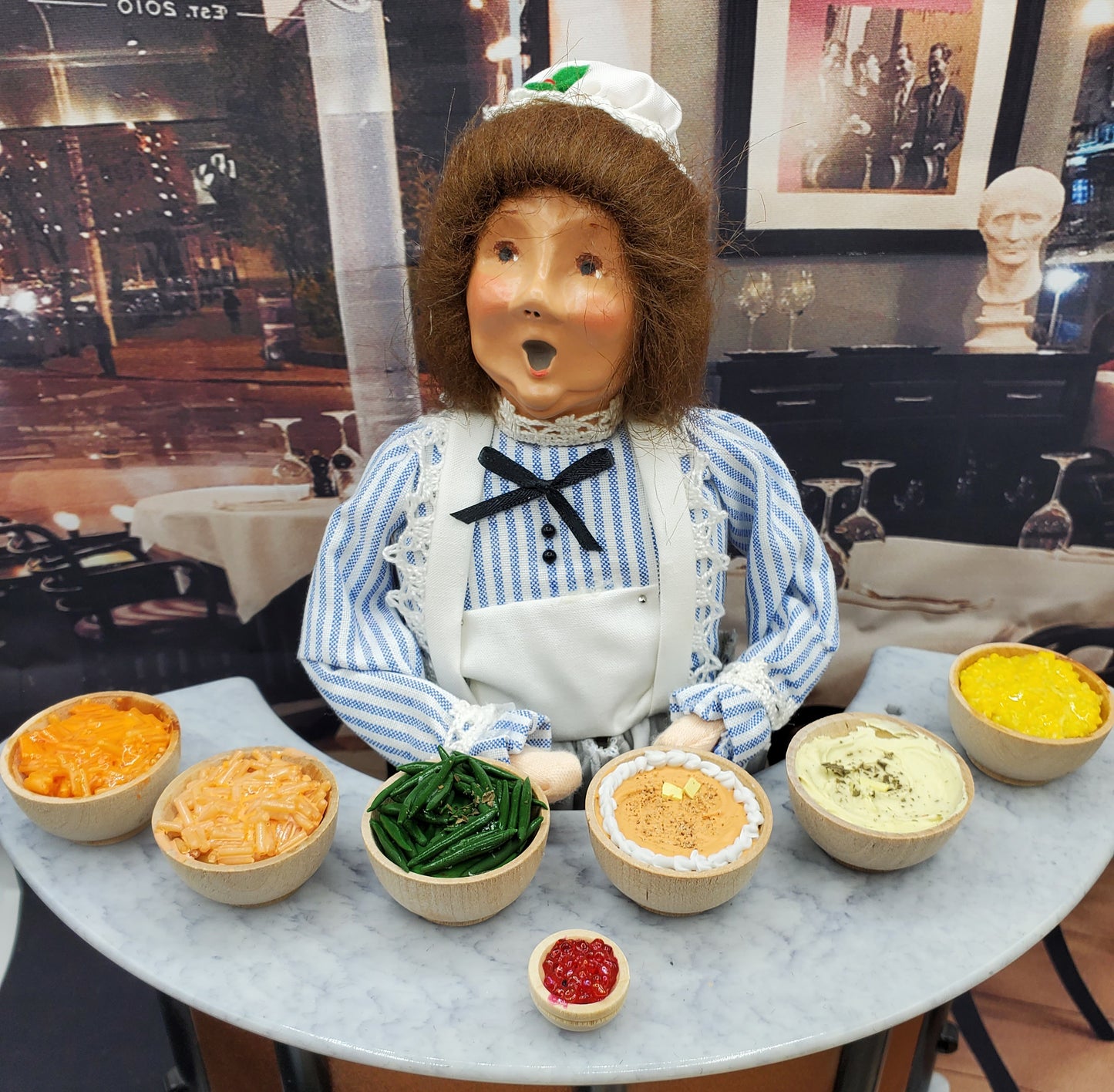 Chef Gina's miniature Yukon Gold mashed potatoes and other sides displayed with a doll in a blue striped outfit