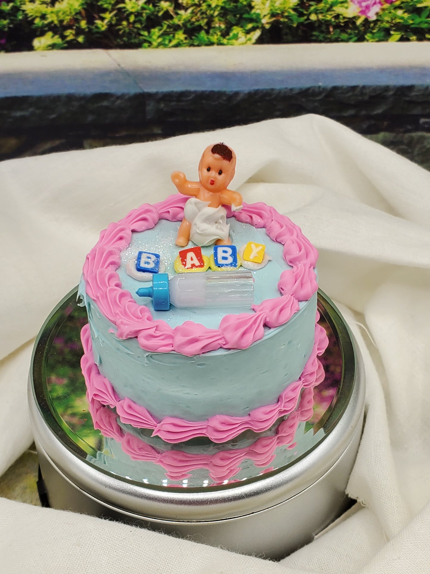 Chef Gina's one sixth scale baby cake with pink frosting, baby doll, and colorful baby blocks on top