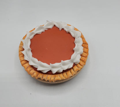 Miniature pumpkin pie for doll displays topped with whipped cream for realistic decor