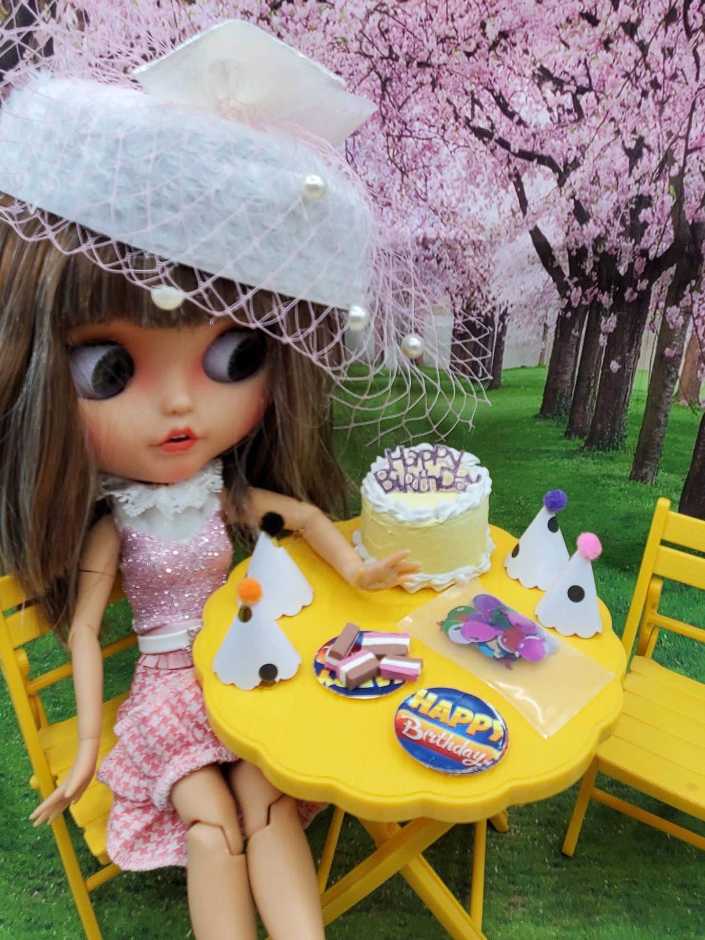 Chef Gina's Mini Food Polka Dot Doll Birthday Set with doll, cake, party hats, and birthday decorations on yellow table
