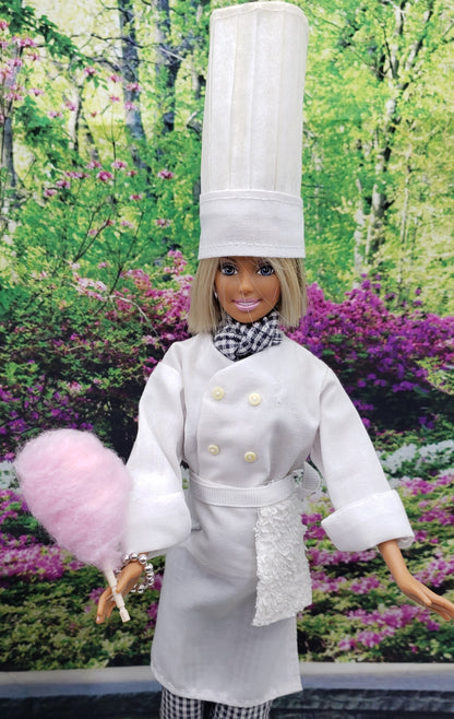 Chef Gina's doll dressed as a chef holding 1:6 scale cotton candy for dolls in a garden background
