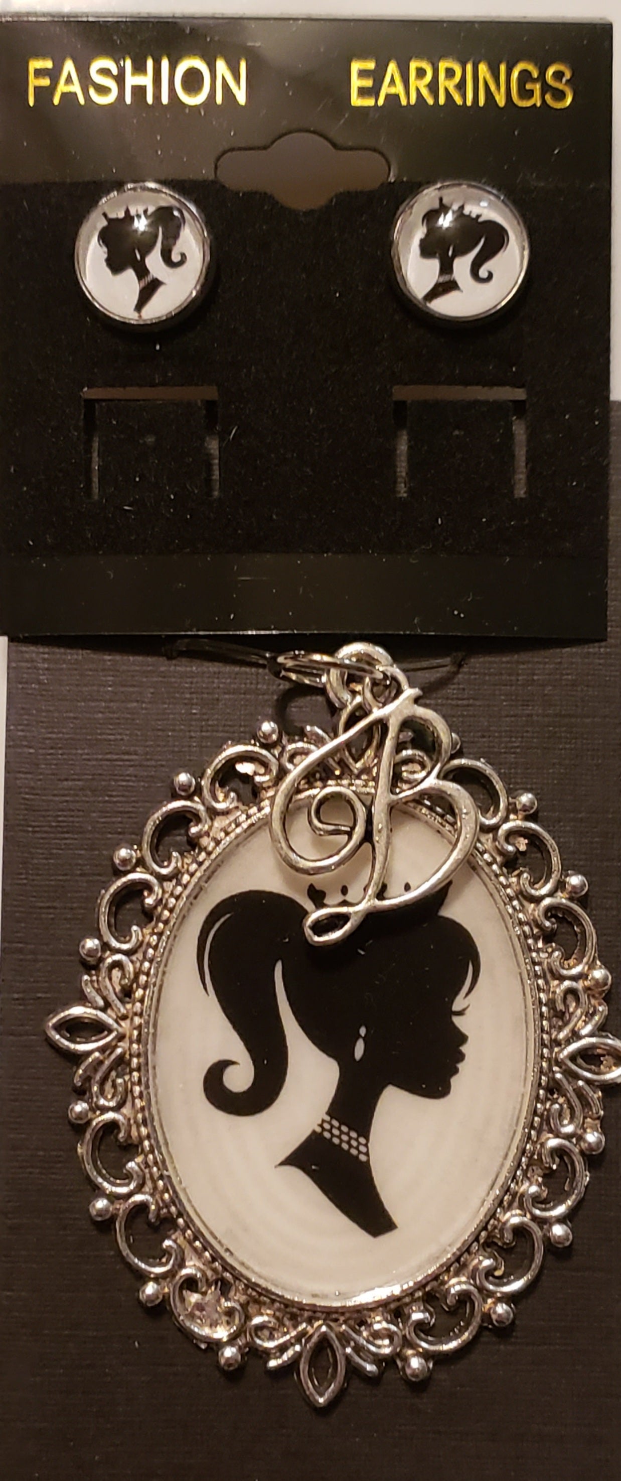 Barbie necklace set featuring black and white silhouette earrings and ornate pendant necklace