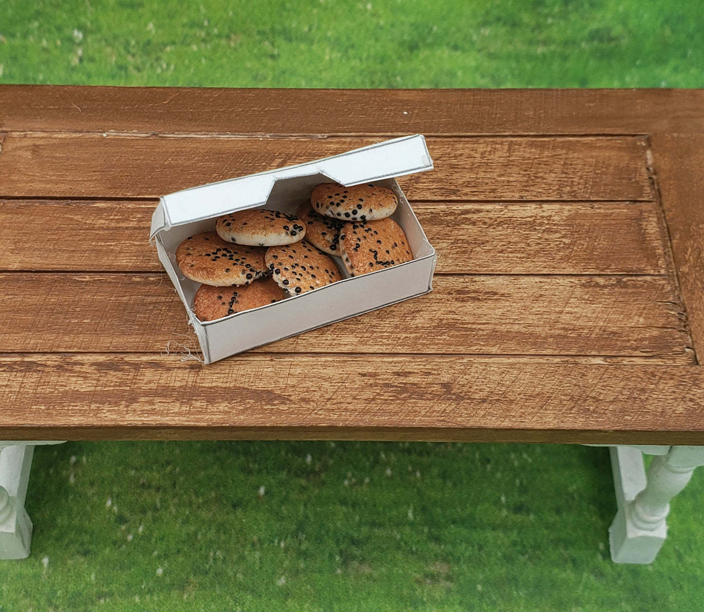 Chef Gina's miniature chocolate chip cookies in a small white box on a wooden doll table