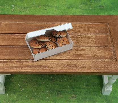 Chef Gina's miniature chocolate chip cookies in a small white box on a wooden doll table