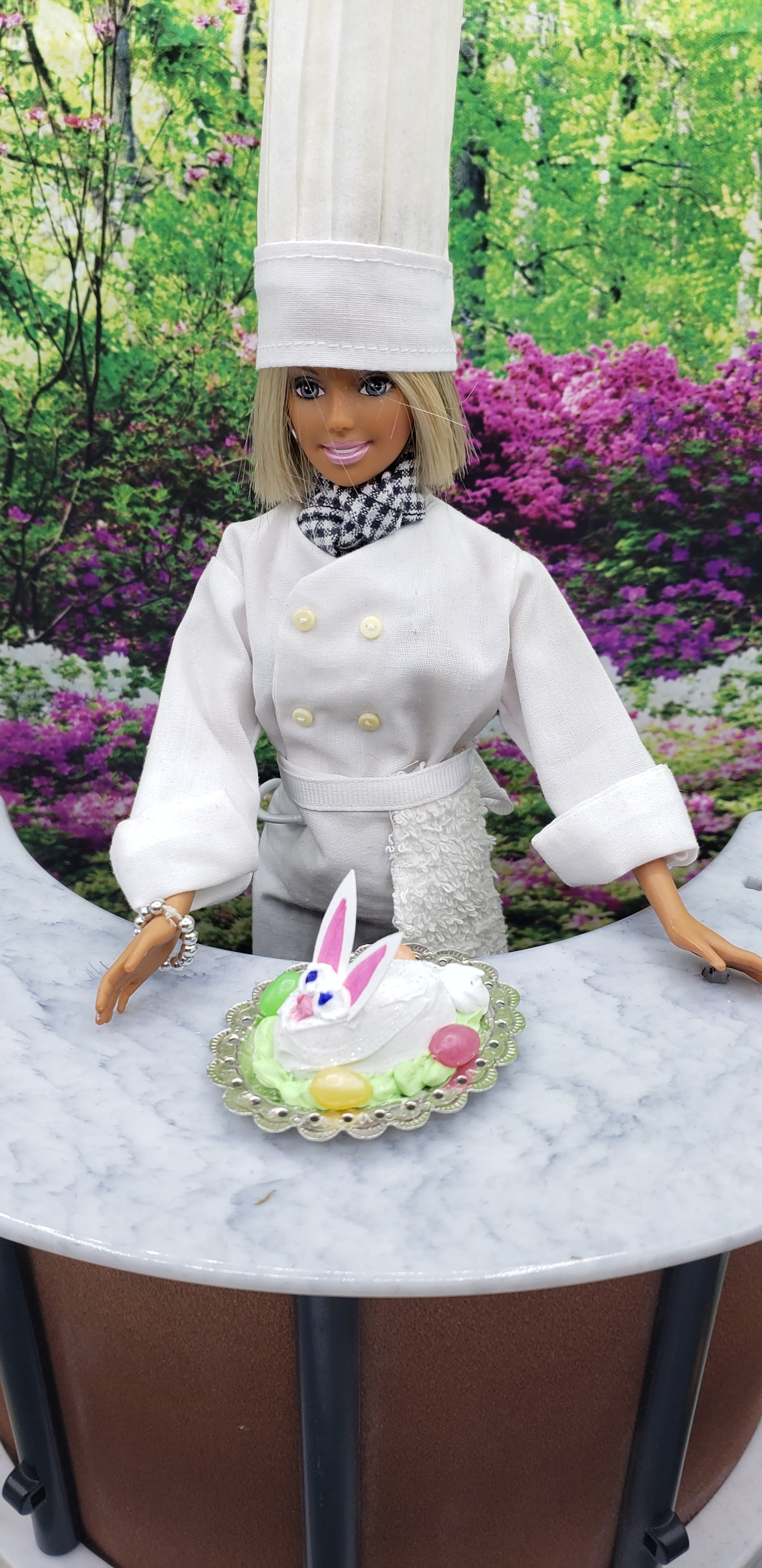 Chef Gina's mini food fashion doll size Easter bunny cake on a plate with colorful decorations outdoors