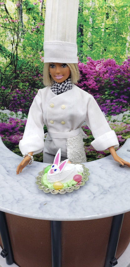 Chef Gina's mini food fashion doll size Easter bunny cake on a plate with colorful decorations outdoors