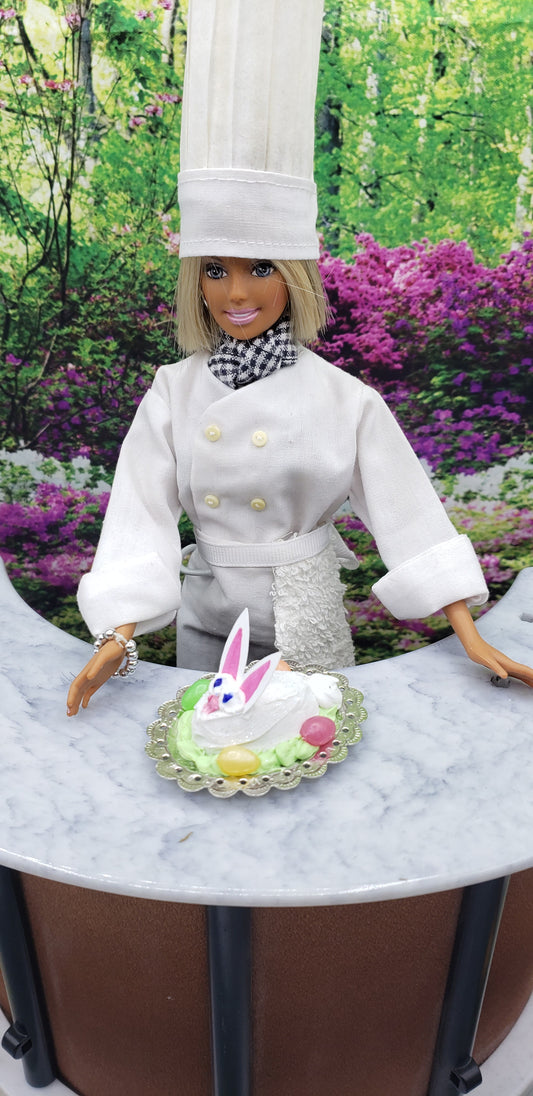Chef Gina's mini food fashion doll size Easter bunny cake on a plate with colorful decorations outdoors