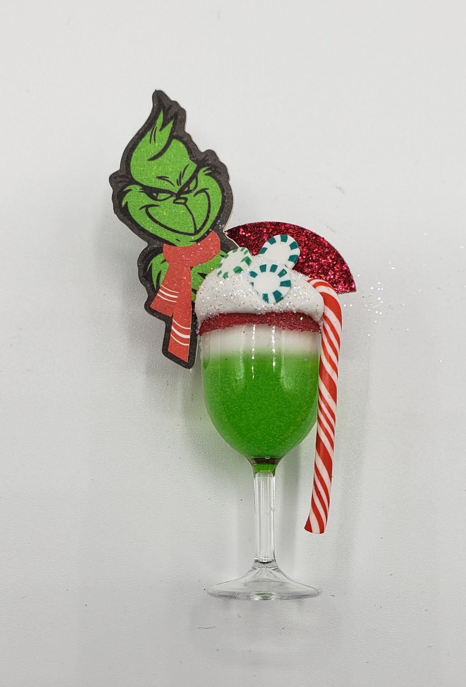 Chef Gina's Mini Food Grinch Christmas doll drink with green layered festive cocktail and candy cane garnish