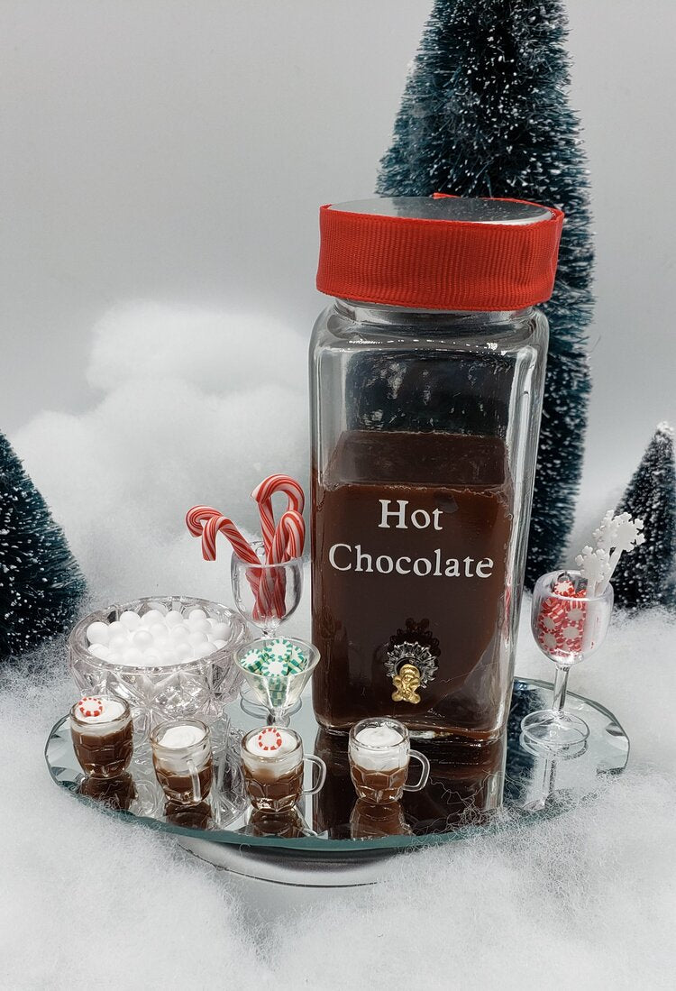 Mini hot chocolate bar for dolls featuring tiny drinks, marshmallows, and festive decorations
