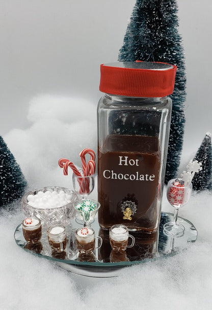 Mini hot chocolate bar for dolls featuring tiny drinks, marshmallows, and festive decorations
