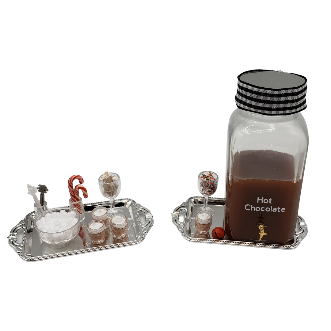 Mini hot chocolate bar for dolls featuring decorative trays with mugs, candy canes, and toppings
