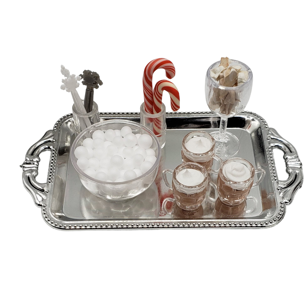 Mini hot chocolate bar for dolls with marshmallows, candy canes, and chocolate cups on a silver tray
