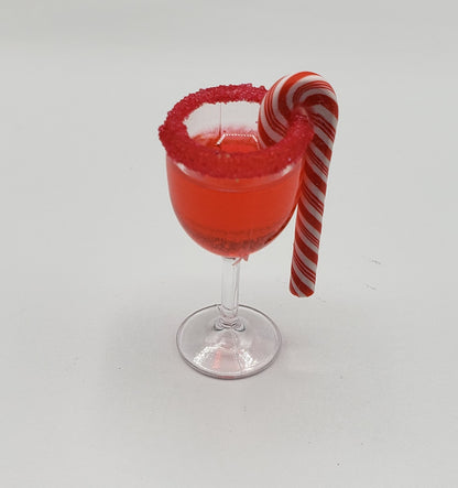 Chef Gina's miniature candy cane drink with red sugar rim and striped candy cane on clear glass