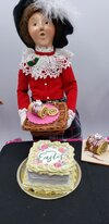 Chefginas miniature Easter Swiss roll cake displayed with a decorative doll in traditional attire