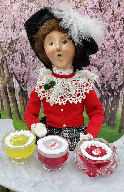 ChefGinas miniature jello trifle displayed with a decorative figure in a spring garden setting