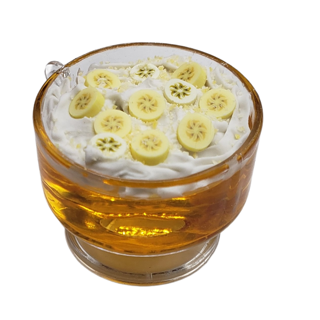 Delicious miniature jello trifle with whipped cream and banana slices in a clear cup