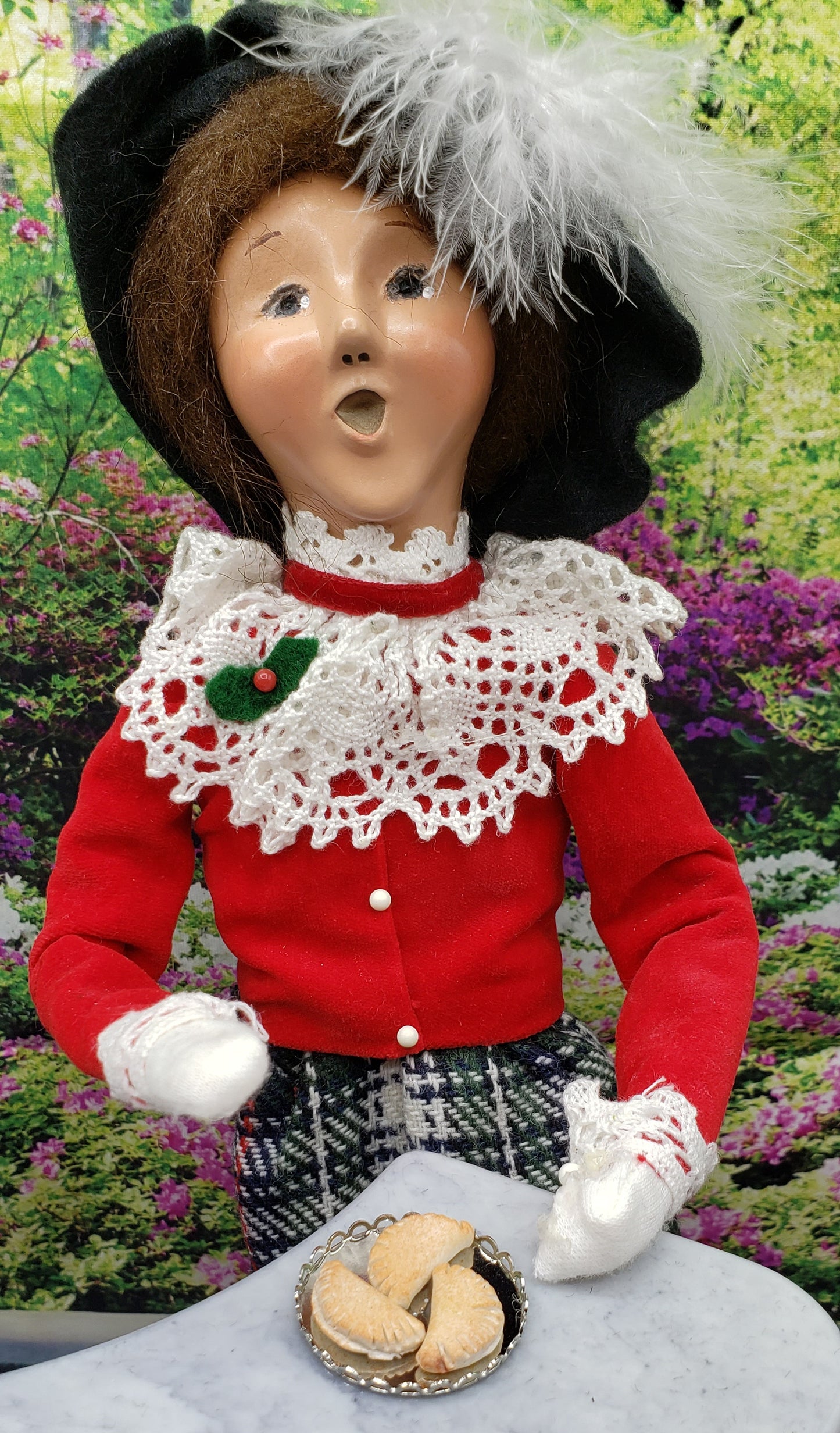 Chef Gina’s miniature pierogi for dolls displayed on a tray with a doll in traditional attire