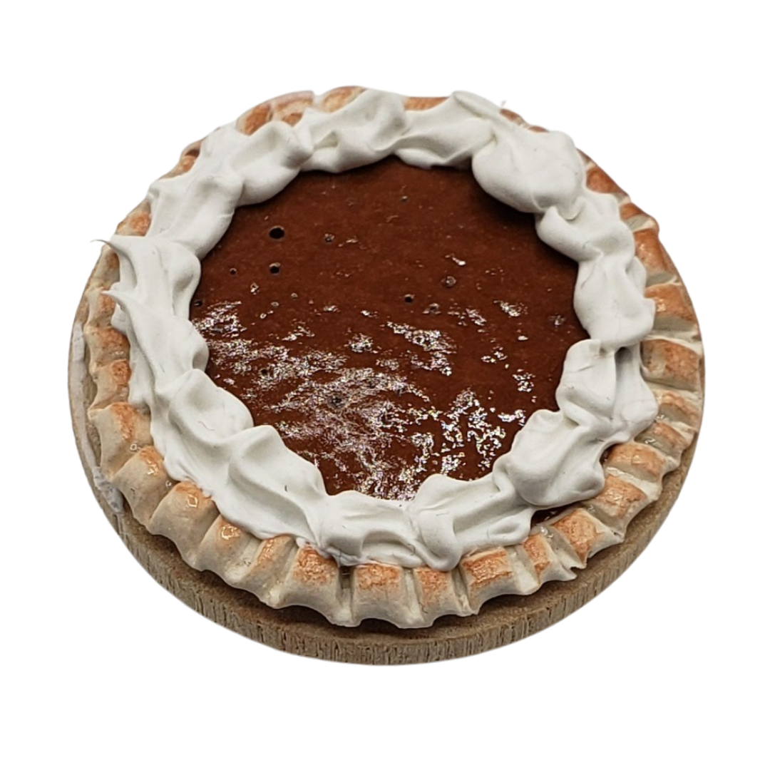 One sixth scale chocolate pie with whipped cream topping and detailed crust design